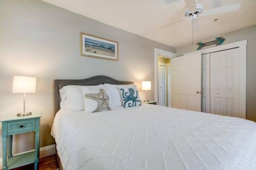 a bedroom with a large white bed and a blue night stand at Rare- Downtown 2 bedroom! Family friendly! in Dunedin