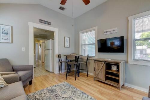 a living room with a tv and a table with chairs at Rare- Downtown 2 bedroom! Family friendly! in Dunedin