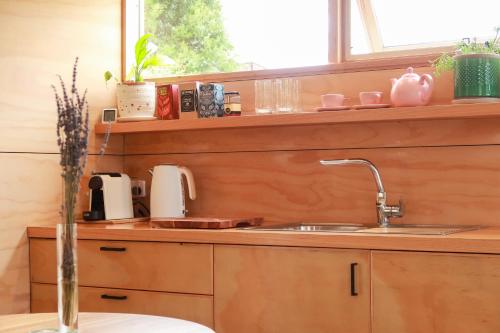 a kitchen counter with a sink and a window at Escape to a Peaceful Eco Studio in Private Garden in Yapeen