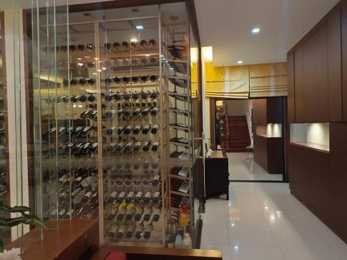 a wine cellar with a wall of wine bottles at Eco stay - Luxury pool + Seaview Villa in North Pattaya