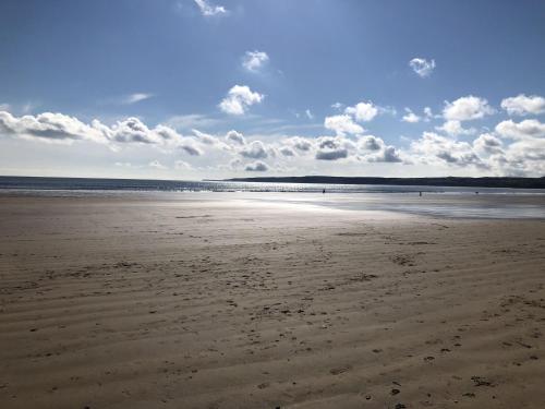 an empty beach with footprints in the sand at Seascape Apartment in Filey