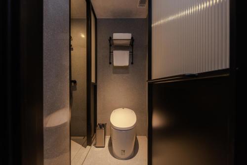 a small bathroom with a toilet and a sink at Mia Hotel - Shanghai Shaanxi South Road in Shanghai