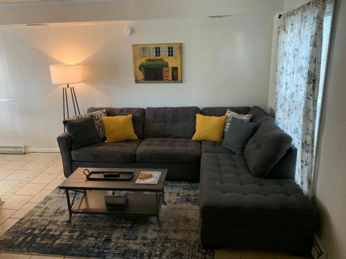 a living room with a couch and a coffee table at Suite 4, Sleep 5, Walk to Attractions in Uptown in Charlotte