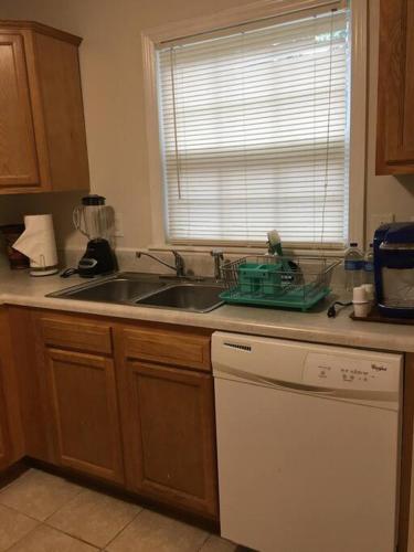 a kitchen counter with a sink and a dishwasher at Suite 4, Sleep 5, Walk to Attractions in Uptown in Charlotte