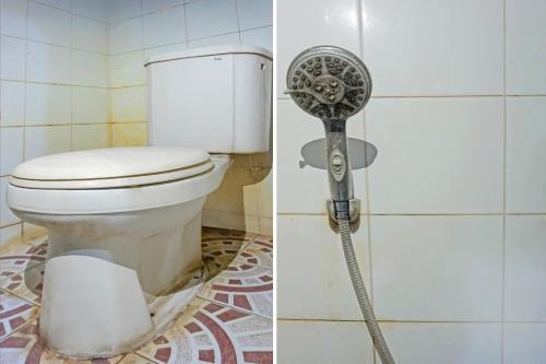a bathroom with a toilet and a shower fan at Hotel O Diamond Inn Makassar in Makassar