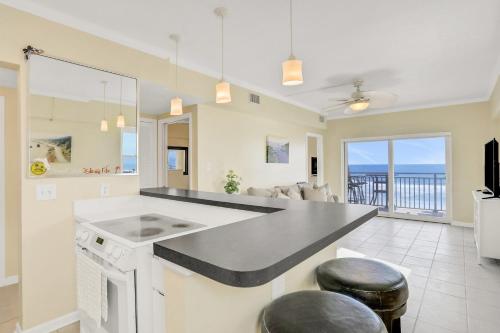 a kitchen and living room with a view of the ocean at Beachside Surf Haven in Jacksonville Beach