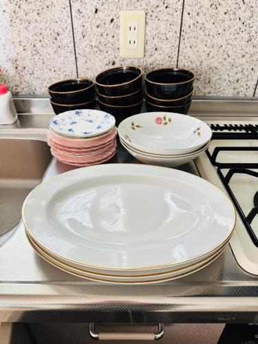 a group of plates sitting on a counter in a kitchen at Shanshui House Shin asahi in Takashima