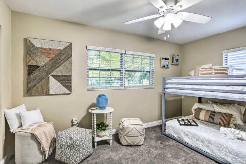 a bedroom with a bunk bed and a ceiling fan at NEW! Cheerful bungalow with hot tub near beaches in Bay Pines