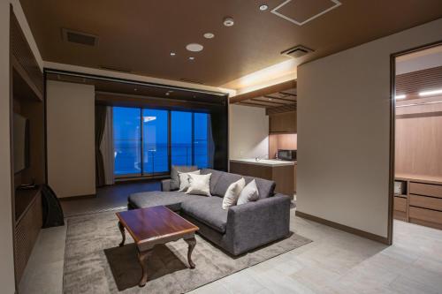 a living room with a couch and a table at AMANE resort SEIKAI in Beppu
