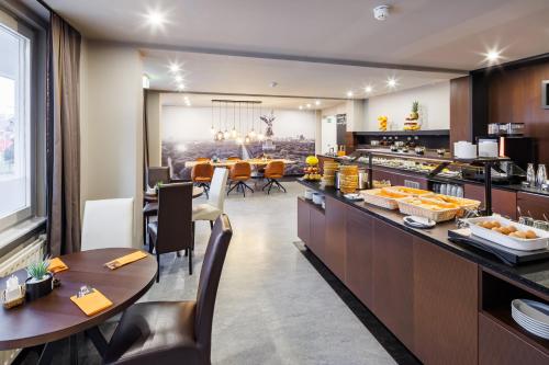 a kitchen and dining room with a buffet and a table at Hotel Lützow in Berlin