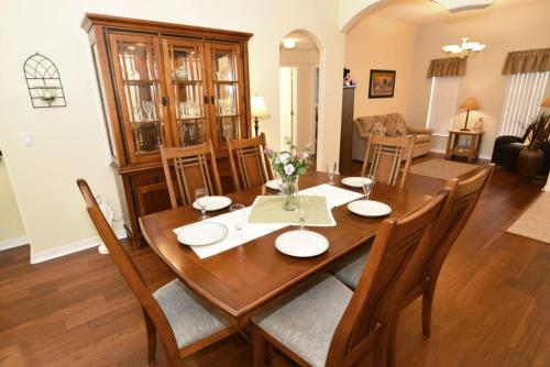 a dining room and living room with a table and chairs at Lovely Lakeside 4-Bed Pool Home at Villa Sol-3125 home in Kissimmee