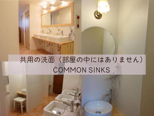 a bathroom with three sinks and a mirror at USJに一番近いゲストハウス J-Hoppers Osaka Universal in Osaka