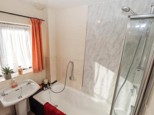 a bathroom with a tub and a sink and a shower at No 5 Main Street in Hull