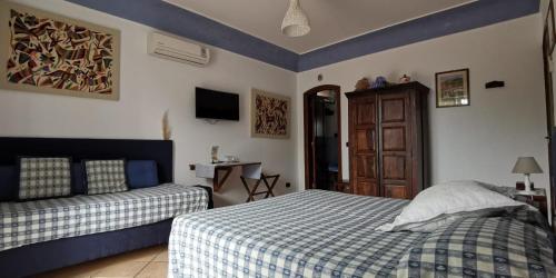 a bedroom with two beds and a television in it at B&B The Sunset in Anacapri