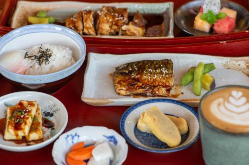 a table topped with different types of food in containers at Onsen at Moncham in Mae Rim