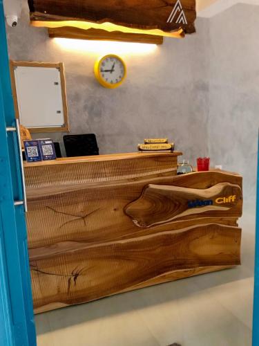 a wooden desk with a clock on a wall at Urban Cliff Resort in Varkala