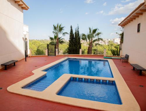 a swimming pool in the middle of a house at Open view Pinetree penthouse in Dehesa de Campoamor