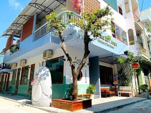 a building with a tree in front of it at Little Quy Nhơn Homestay in Quy Nhon