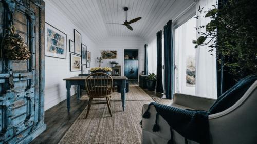 a dining room with a table and a chair at Mill House Studio - a romantic retreat in Lyonville