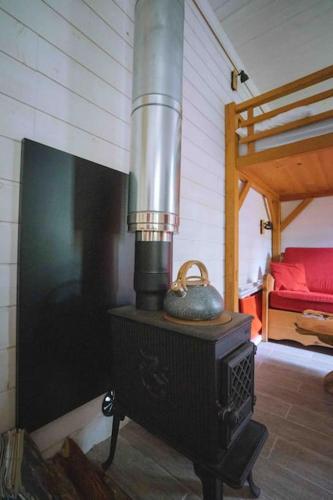 - une cuisinière avec une bouilloire dans l'établissement Le chalet du bout du monde, en bord de rivière !, à Grez-sur-Loing