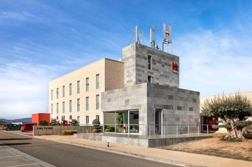 a building with a tower on top of it at Hotel 280 Zaragoza in Calatorao