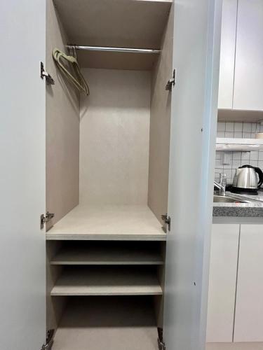 a cupboard in a kitchen with white cabinets at 318 Stay in Seoul