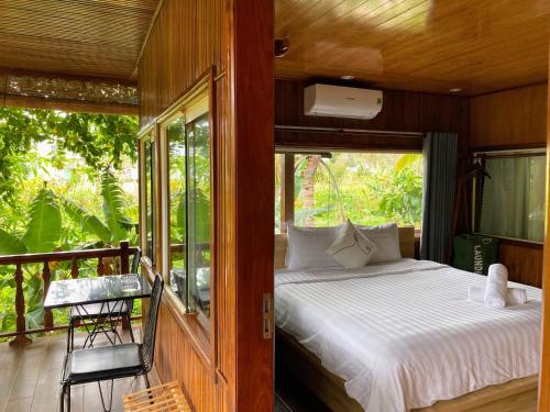 ein Schlafzimmer mit einem Bett und einem Balkon in der Unterkunft Kim's Garden in Con Dao