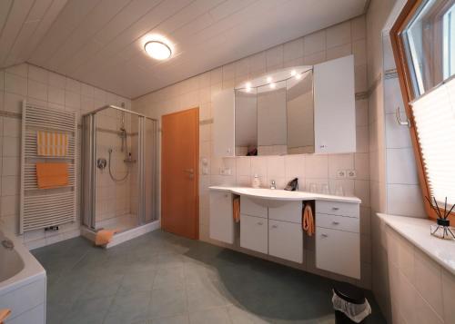 a large bathroom with a sink and a shower at Berggasthaus Braunbergstüble in Oppenau