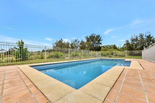 a swimming pool with a fence around it at Silver Springs 6br Luxury Homestead in Rothbury