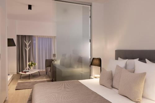 a bedroom with a bed and a living room at L-Avenue in Brussels