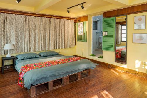 a bedroom with two beds and a window at Hanoi Retro 80S Homestay in Hanoi
