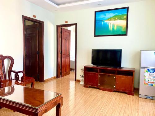 a living room with a flat screen tv on a table at Sky Beach D20 Nha Trang in Nha Trang
