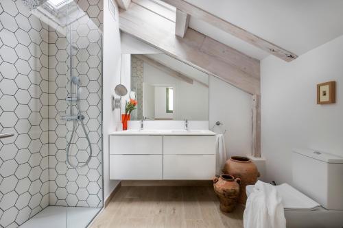 a bathroom with a white sink and a mirror at Calatrava - Darya Living in Madrid