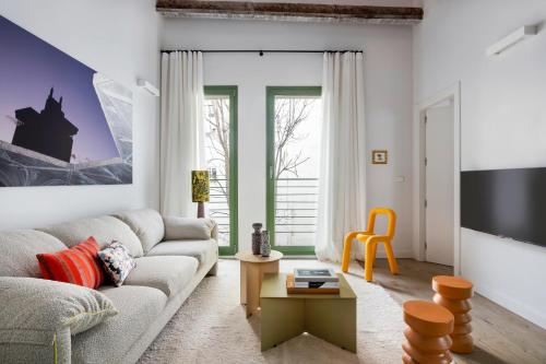a living room with a couch and a tv at Calatrava - Darya Living in Madrid