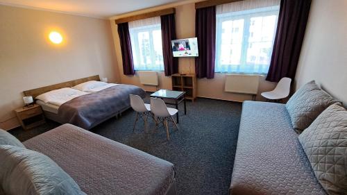 a hotel room with a bed and a couch at Pension PAVIR in Židlochovice
