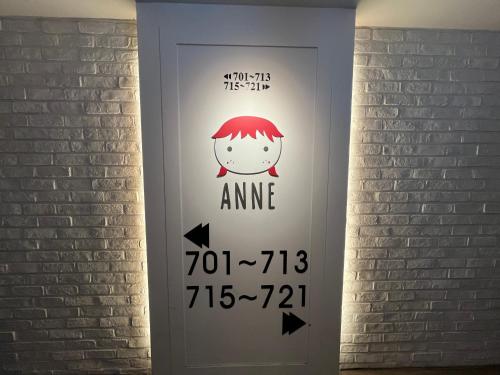 a door with a sign on it with arrows at Hotel Yaja Hwajeong Station in Goyang