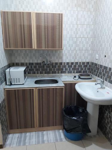 a small bathroom with a sink and a sink at Basma Plaza in Abha