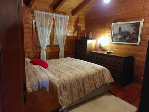 1 dormitorio con 1 cama y vestidor en una cabaña en Chalet sa end my, en Sellano