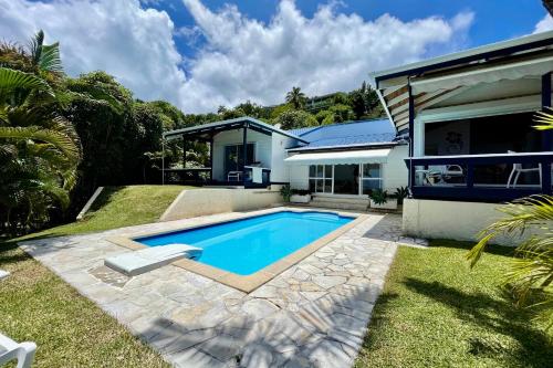 a swimming pool in the backyard of a house at Villa Tiare amazing view - private pool - 4 bedrooms- up to 7 pers in Punaauia