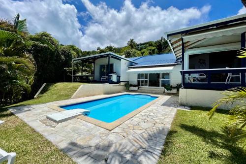 a swimming pool in the backyard of a house at Villa Tiare amazing view - private pool - 4 bedrooms- up to 7 pers in Punaauia