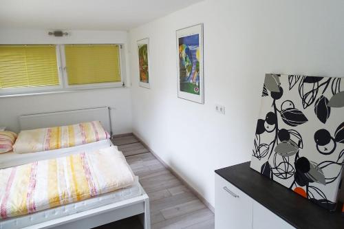 a small room with a bed and a desk at cozy 3 room Apartment in Bergisch Gladbach