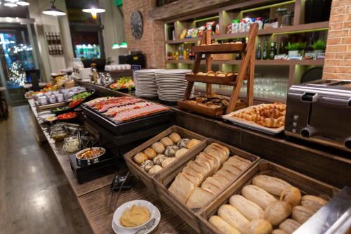 a bakery with a variety of bread and pastries on display at Estilo Fashion Hotel Budapest in Budapest