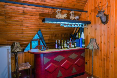 a bar in a wooden room with bottles of alcohol at Blue Moon Residency in Nuwara Eliya