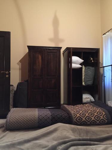 a bedroom with a bed and a wooden cabinet at The Knight and the Pomegranate - Luxury Medieval Villa in Rhodes Town