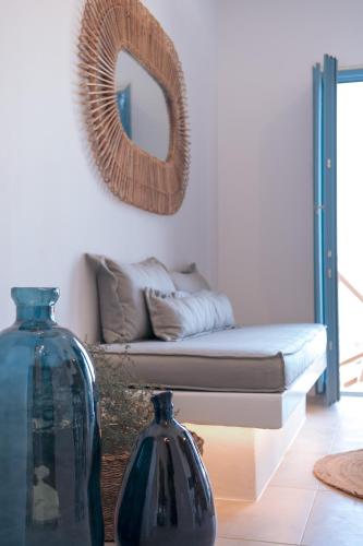 a living room with a couch and two vases at Anemela Villas & Suites Mykonos in Agrari