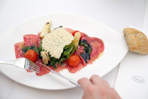 a plate of food with a person holding a fork at Wallseerhof in Wallsee