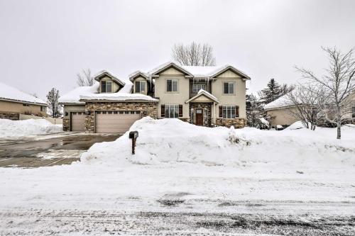 a house with a lot of snow in front of it at Utah Abode - Deck, Arcade Games and Near Skiing in Midway