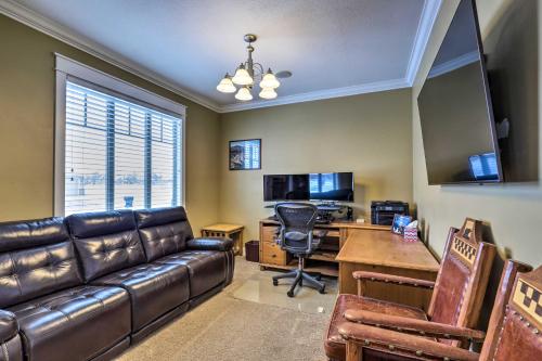 a living room with a leather couch and a desk at Utah Abode - Deck, Arcade Games and Near Skiing in Midway