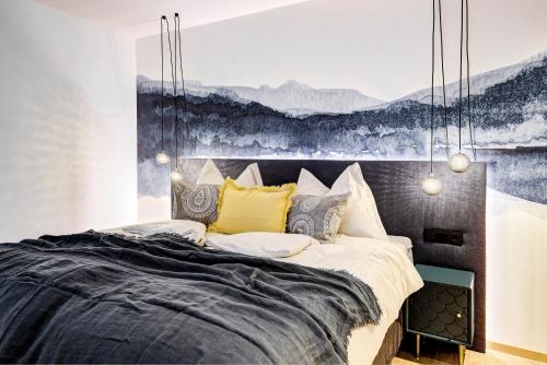 a bedroom with a large bed with a painting on the wall at Königswieser Hof in Königswiesen
