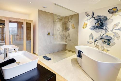 a bathroom with a tub and a sink and a shower at Königswieser Hof in Königswiesen